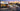Alt text: OneMiners Hosting storefront with New York City skyline at sunset and promotional text announcing the opening of a new NYC office