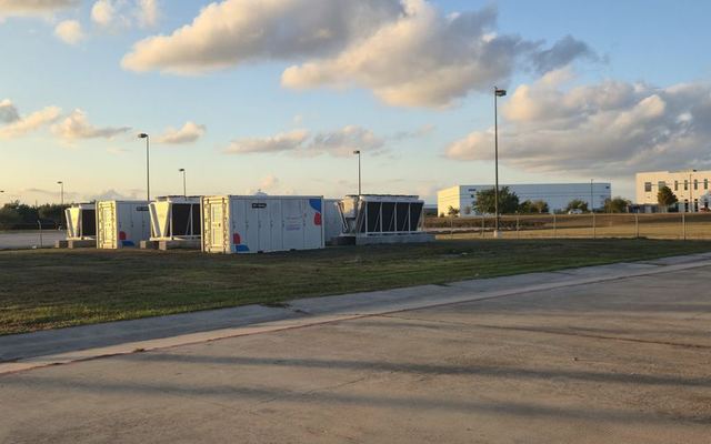 Hydro containers with dry coolers in the Houston yard at sunset