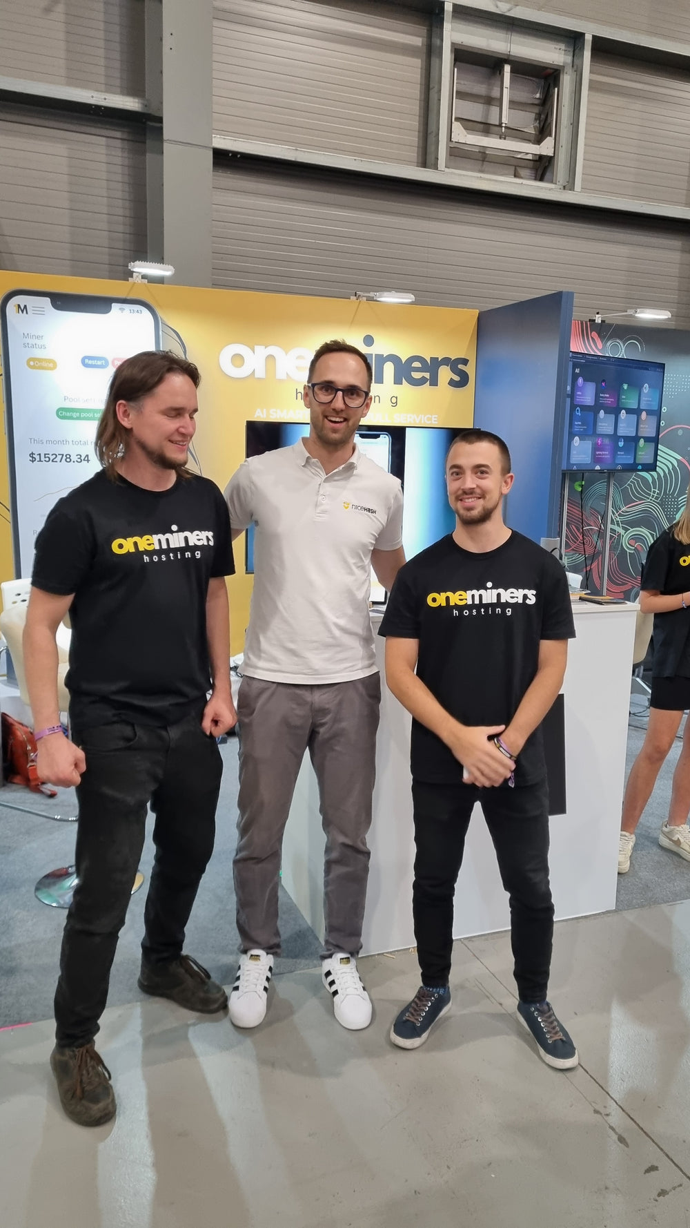 Three people standing in front of a 'Crayters' branded backdrop