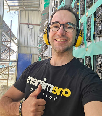 CEO at the Ethiopian hosting center giving a thumbs-up in front of mining equipment with yellow ear protection.