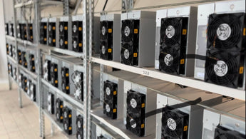 Rack of ASIC miners with multiple fans installed on each unit in a mining facility.